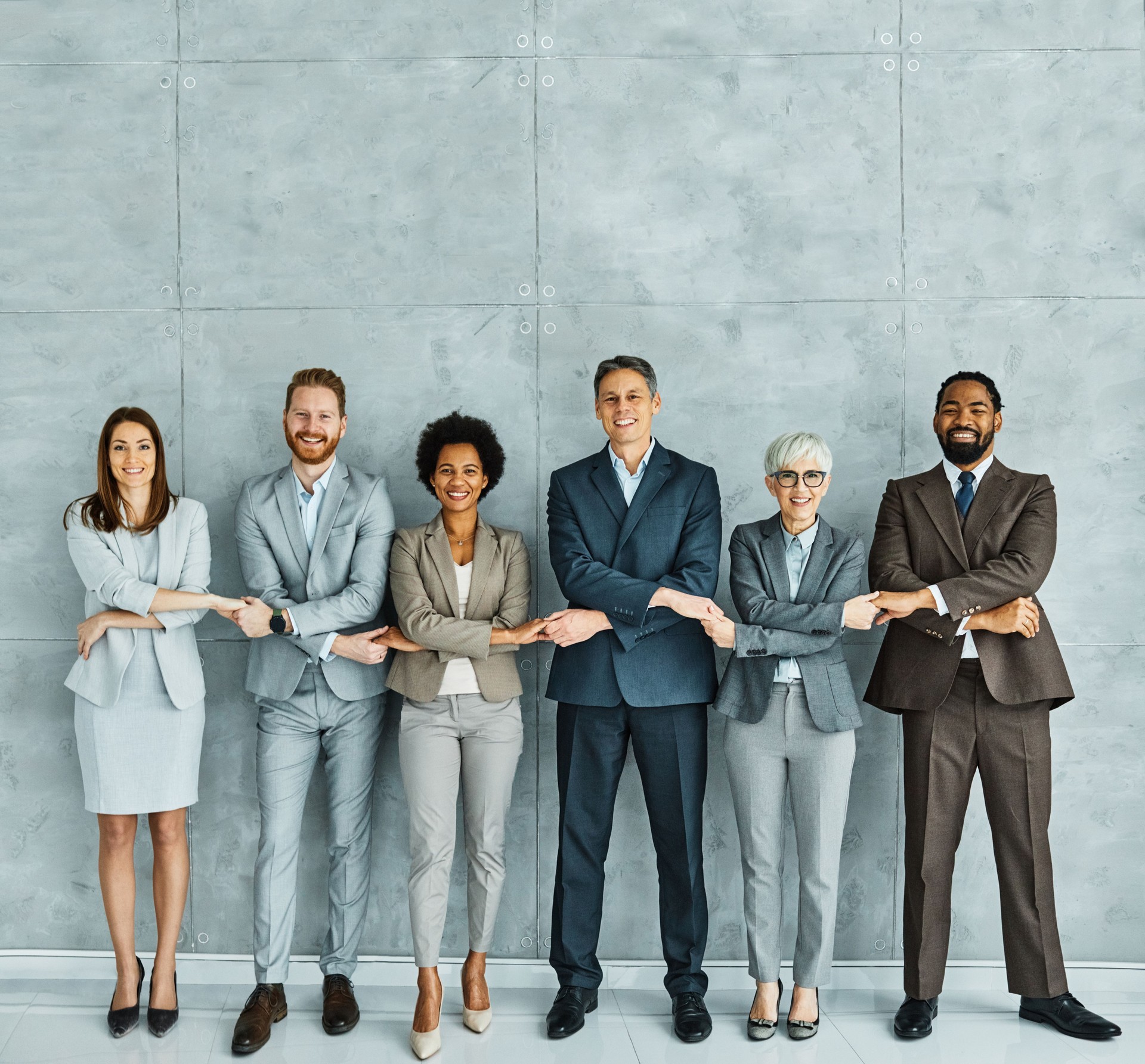 young business people meeting office portrait diversity teamwork group connection success holding hands unity senior mature colleague together